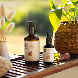 Cruelty-free body oil bottles displayed with natural decor, including a woven plant pot and dried floral accents.